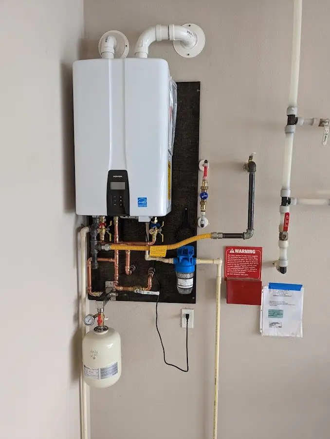 Professional plumber installing copper piping in a Paterson home